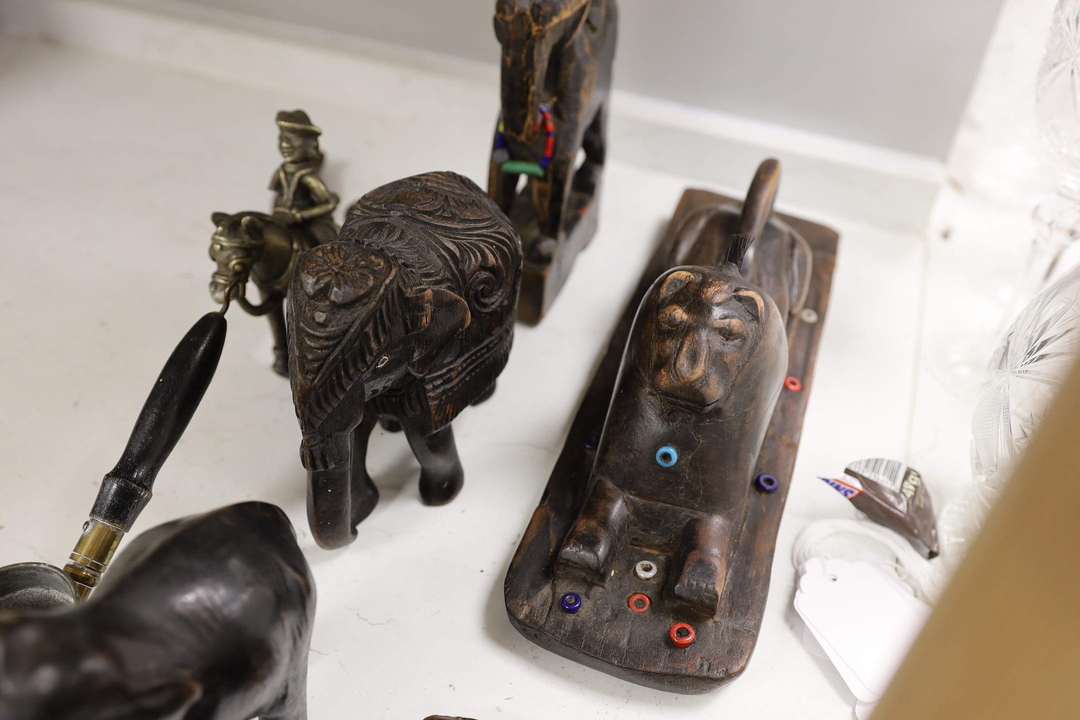 A quantity of Indian carvings and cast brass figures, tallest 20cm